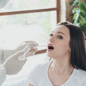 A woman getting a saliva sample