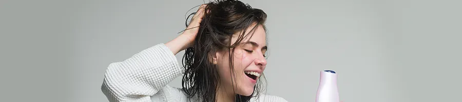 female smiling while touching head
