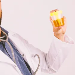 A doctor holding a bottle of pee